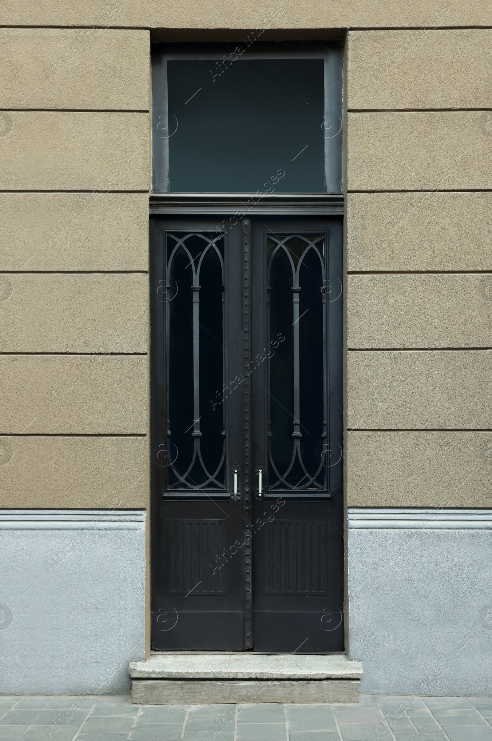 Photo of Entrance of house with beautiful black door and transom window