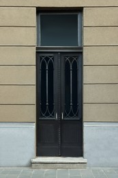 Entrance of house with beautiful black door and transom window