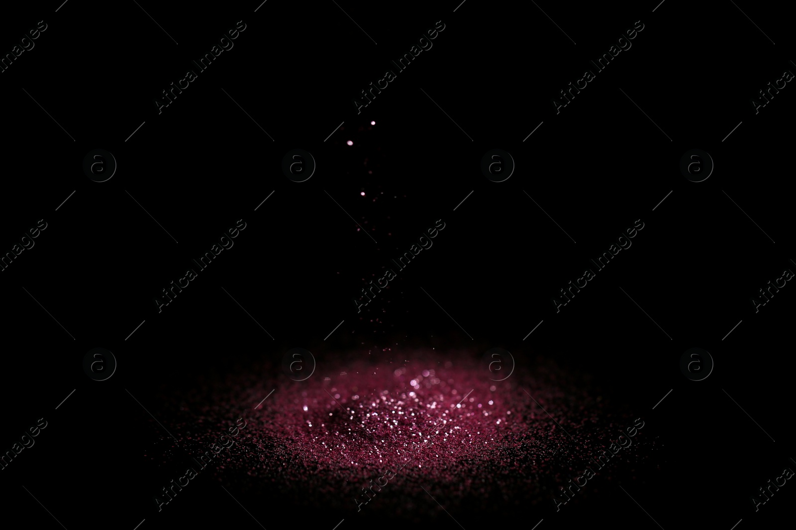 Photo of Heap of rose glitter with bokeh effect on black background