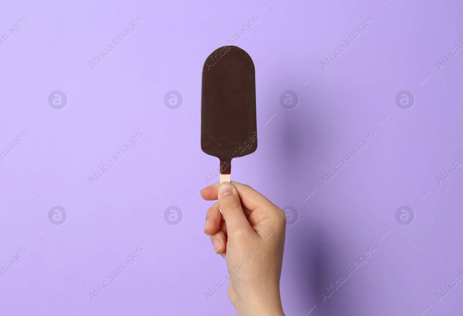 Photo of Woman holding delicious ice cream with chocolate against color background