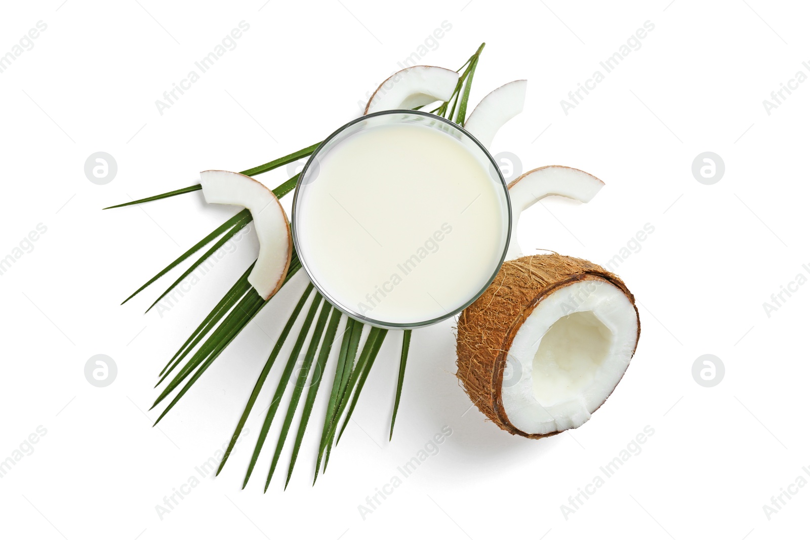 Photo of Glass of coconut milk and nuts on white background, top view