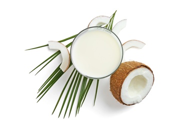 Photo of Glass of coconut milk and nuts on white background, top view