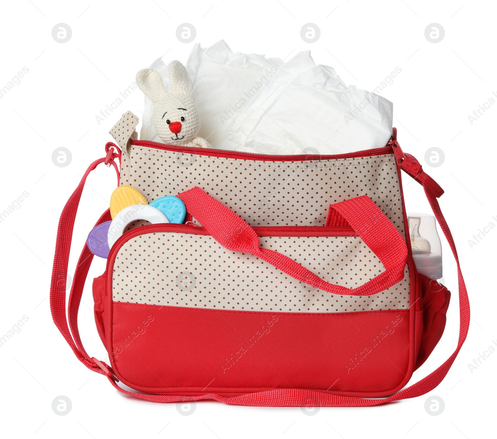 Photo of Maternity bag with disposable diapers and child's accessories on white background