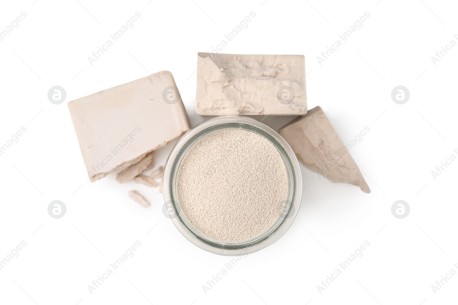 Photo of Compressed and granulated yeast on white background, top view