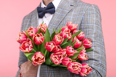 Photo of Man with beautiful bouquet on pink background, closeup