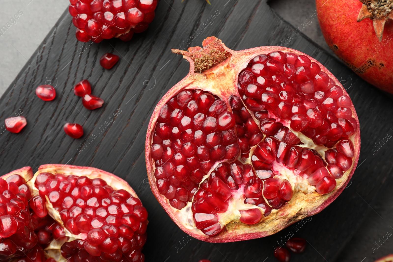 Photo of Cut fresh pomegranate on table, top view