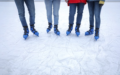Photo of Friends at ice skating rink outdoors, closeup. Space for text