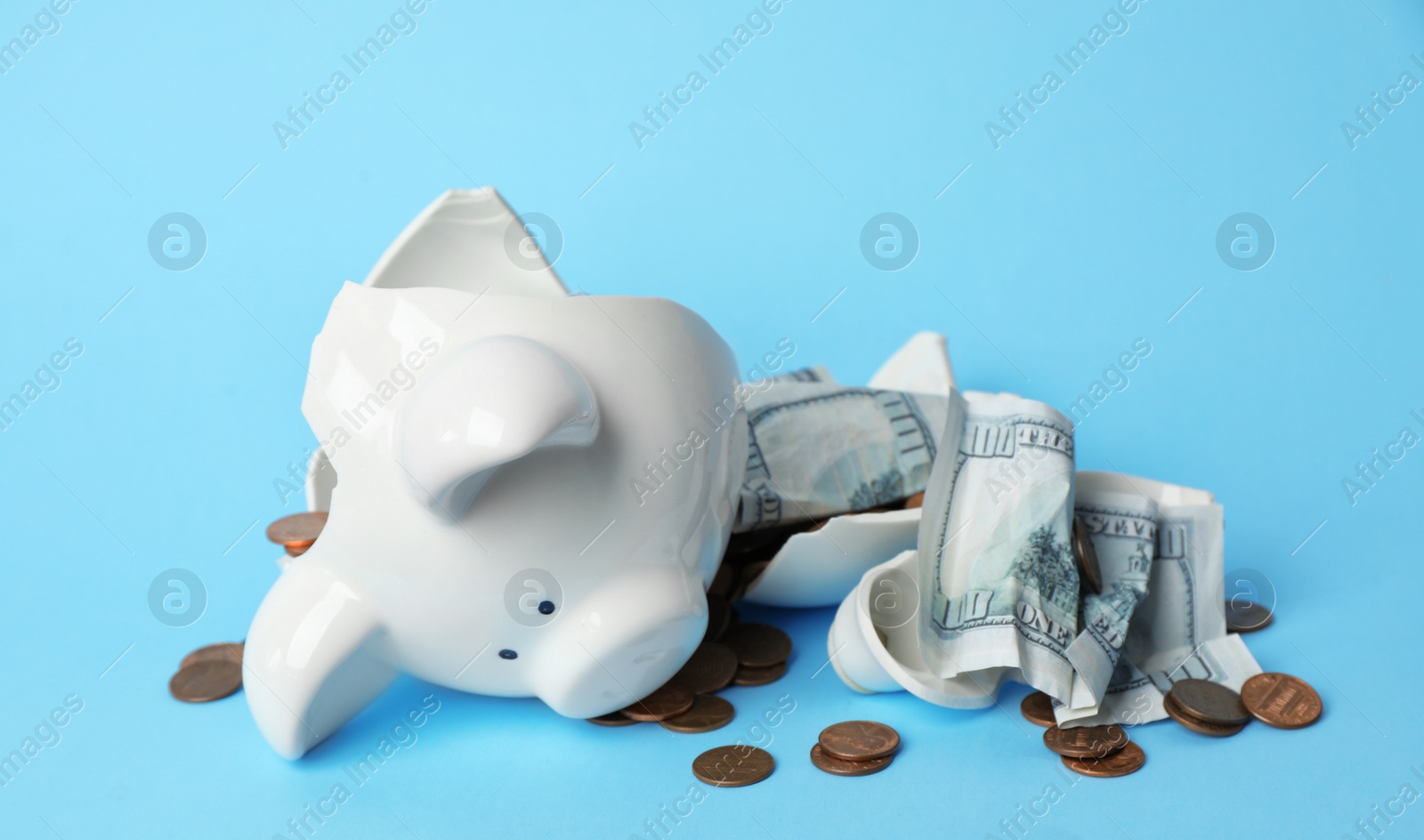 Photo of Broken piggy bank with coins and banknotes on color background
