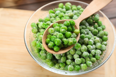 Photo of Frozen green peas on table, closeup. Vegetable preservation