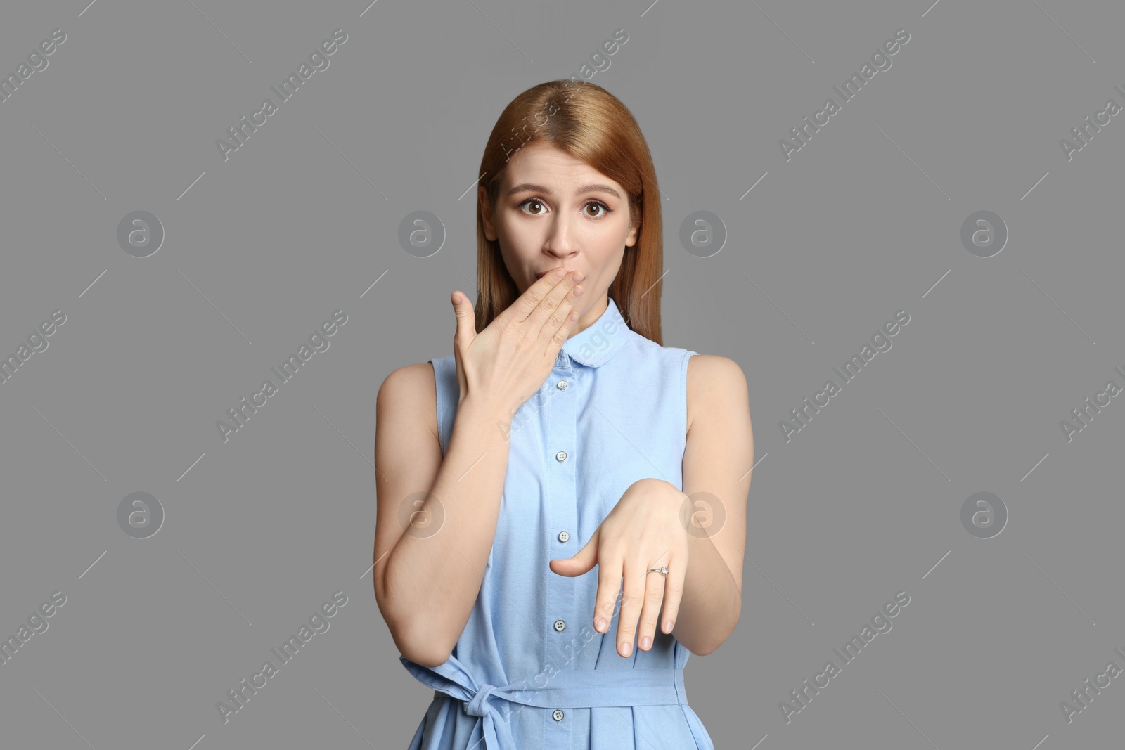 Photo of Emotional woman with engagement ring on light grey background