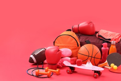 Many different sports equipment on red background, space for text