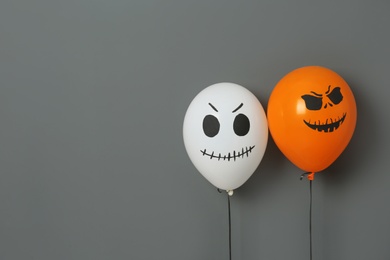 Photo of Color balloons for Halloween party on gray background. Space for text