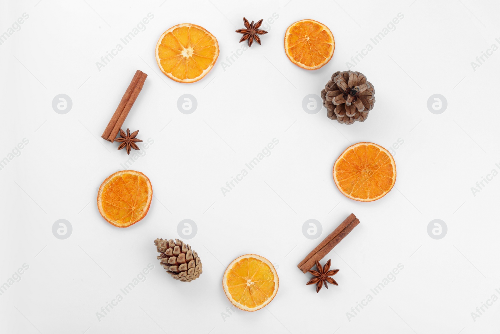 Photo of Frame made of dry orange slices, cinnamon sticks and anise stars on white background, flat lay with space for text
