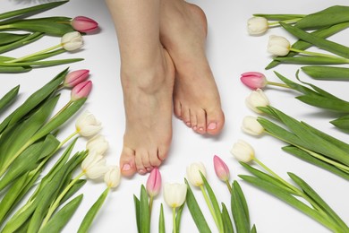 Photo of Woman with neat toenails after pedicure procedure on light background, closeup