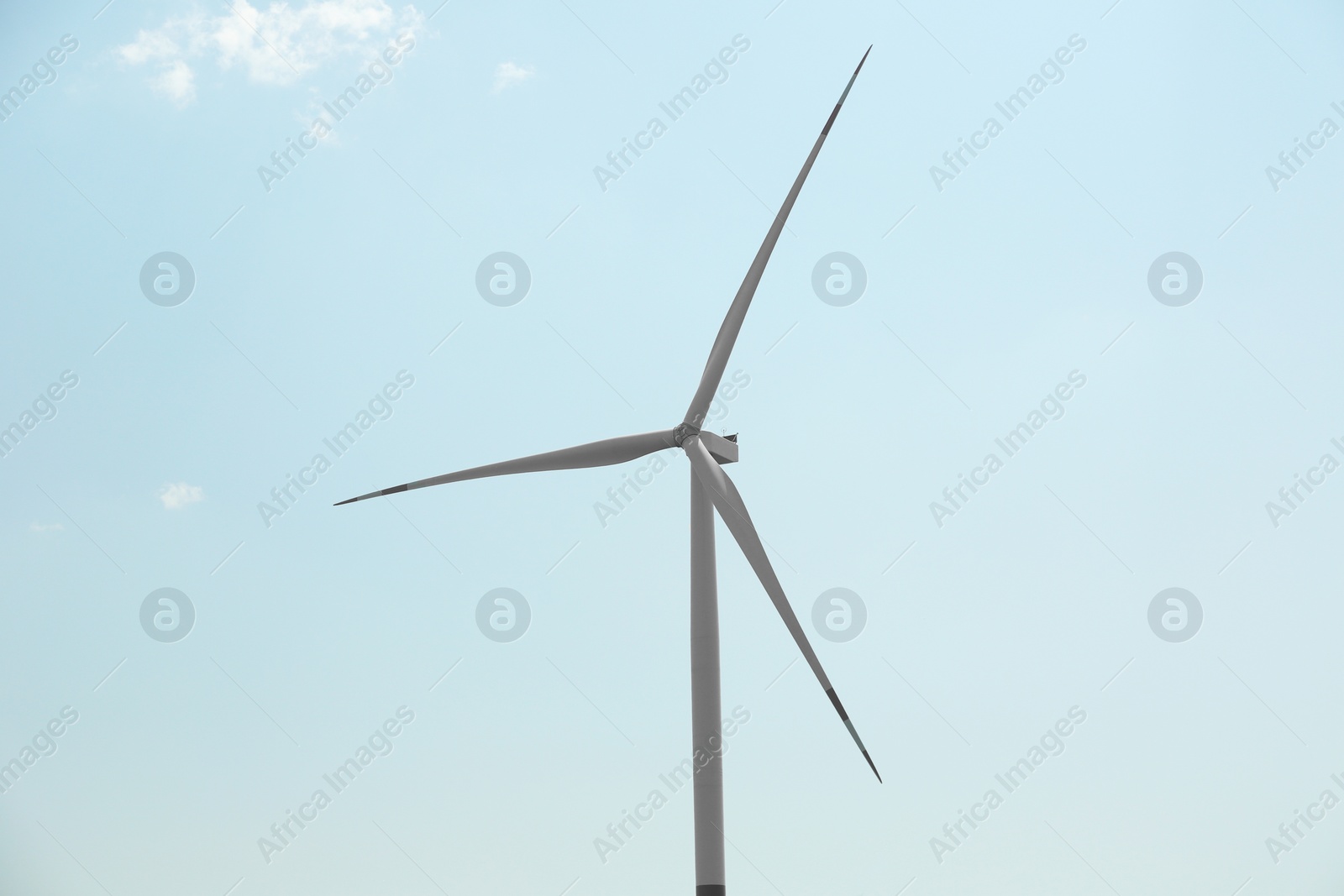 Photo of Modern wind turbines against blue sky. Energy efficiency