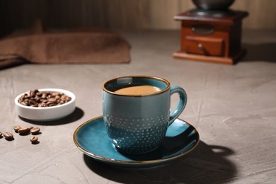 Delicious coffee with milk in cup on light textured table