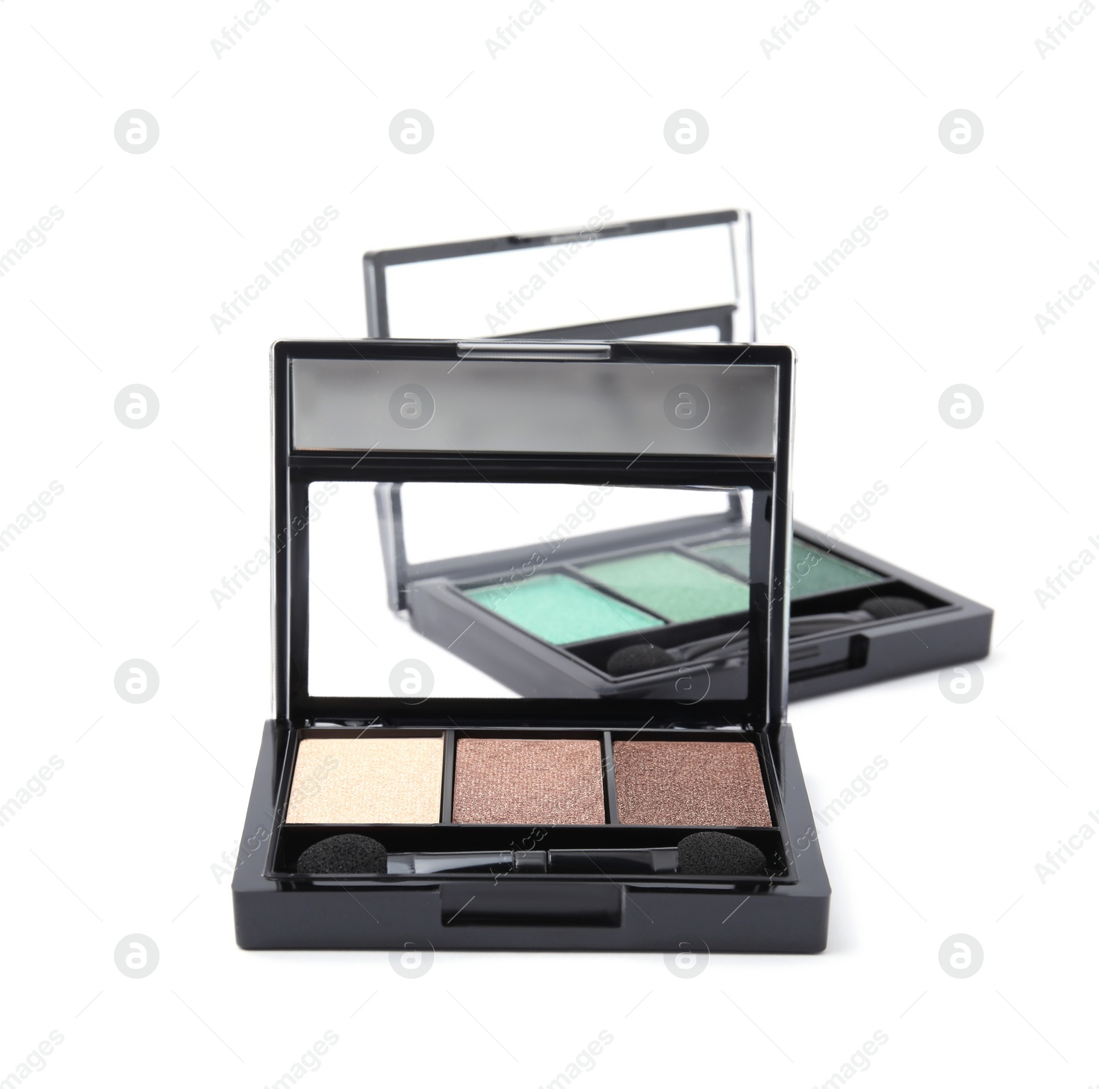 Photo of Beautiful eye shadow palettes with brushes isolated on white