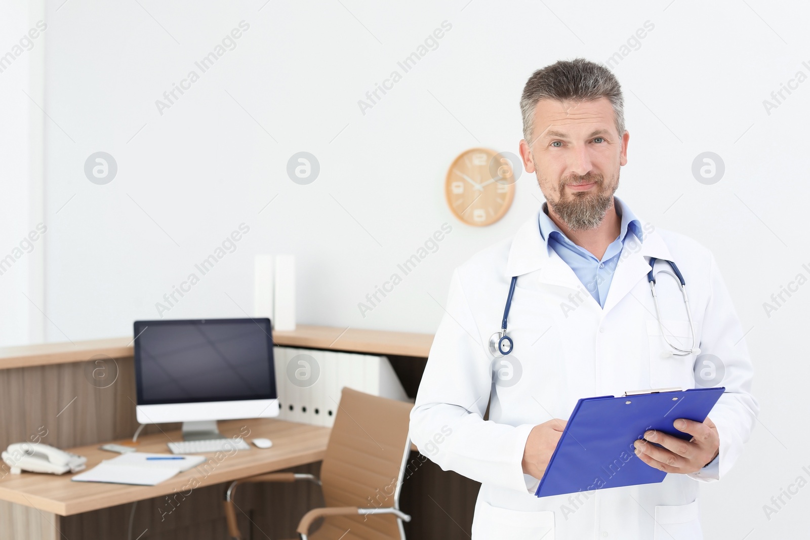 Photo of Male medical assistant near workplace in clinic. Health care service