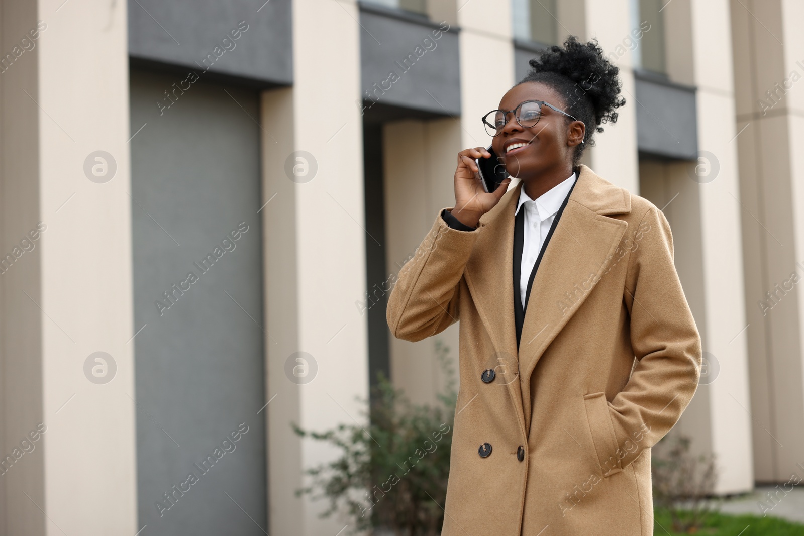 Photo of Happy woman talking on smartphone outdoors, space for text. Lawyer, businesswoman, accountant or manager