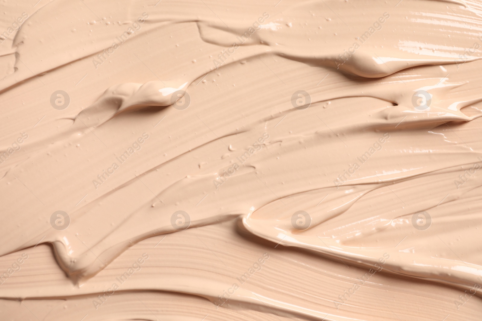 Photo of Texture of skin foundation as background, closeup