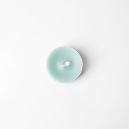 Photo of Light blue wax decorative candle isolated on white, top view