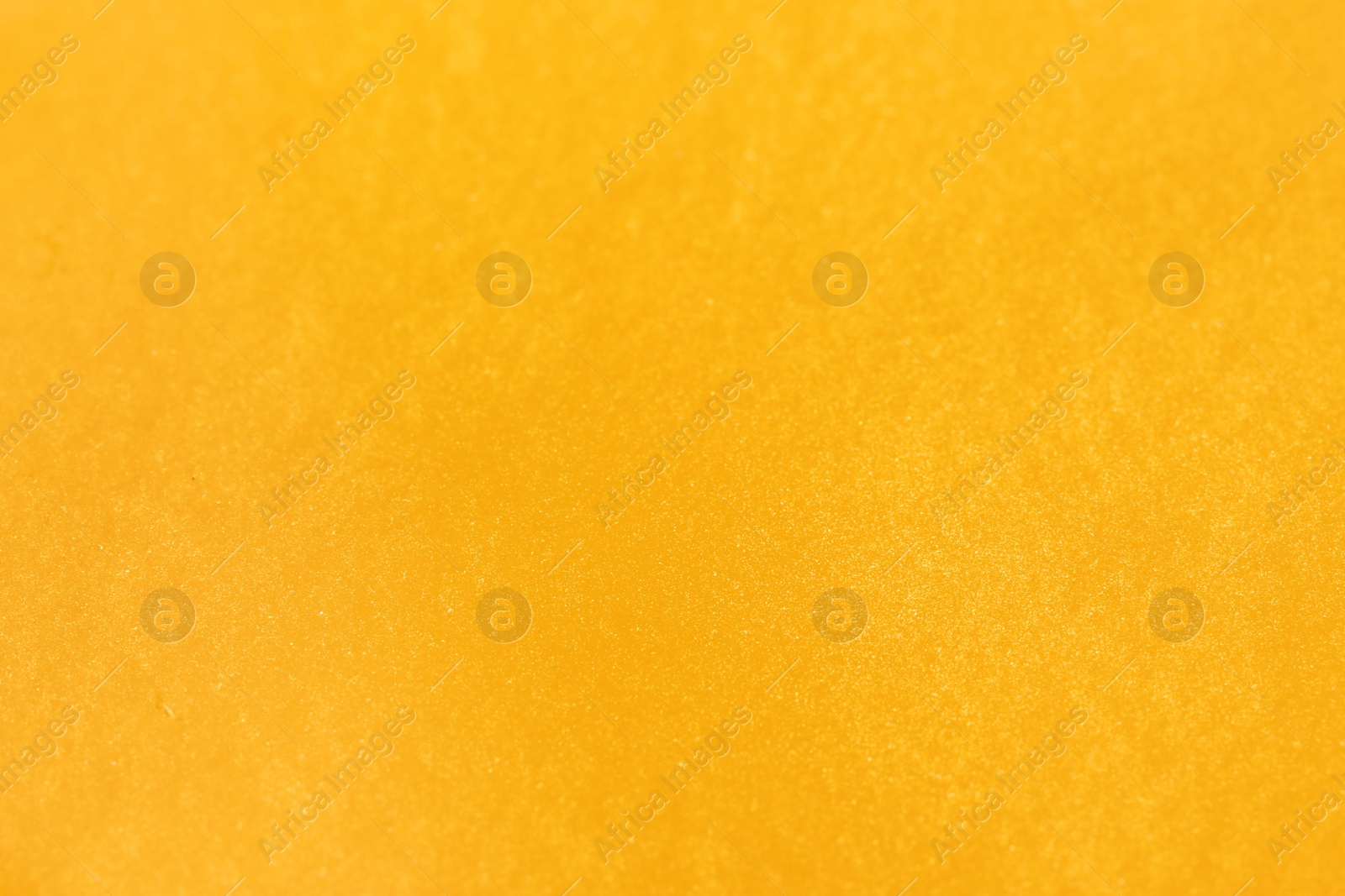 Photo of Closeup view of yellow slime as background. Antistress toy