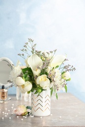 Vase with bouquet of beautiful flowers on table