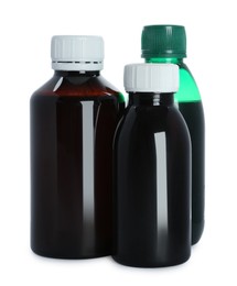 Photo of Bottles of cough syrup on white background