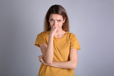 Photo of Portrait of stressed young woman on grey background