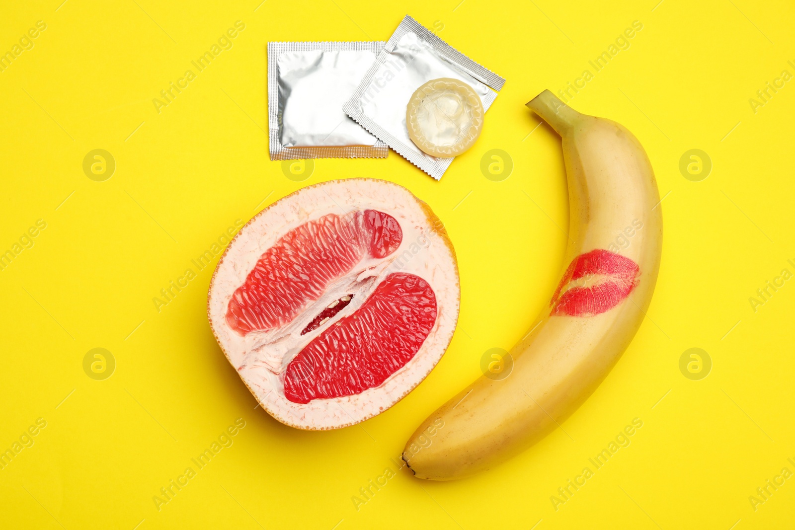 Photo of Flat lay composition with condoms on yellow background. Safe sex