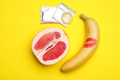 Photo of Flat lay composition with condoms on yellow background. Safe sex