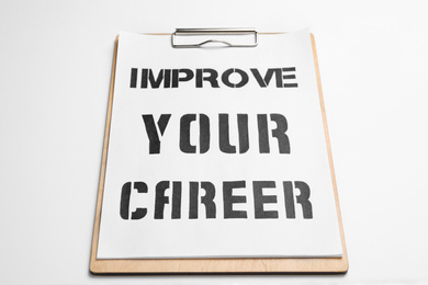 Photo of Clipboard with words IMPROVE YOUR CAREER on white background