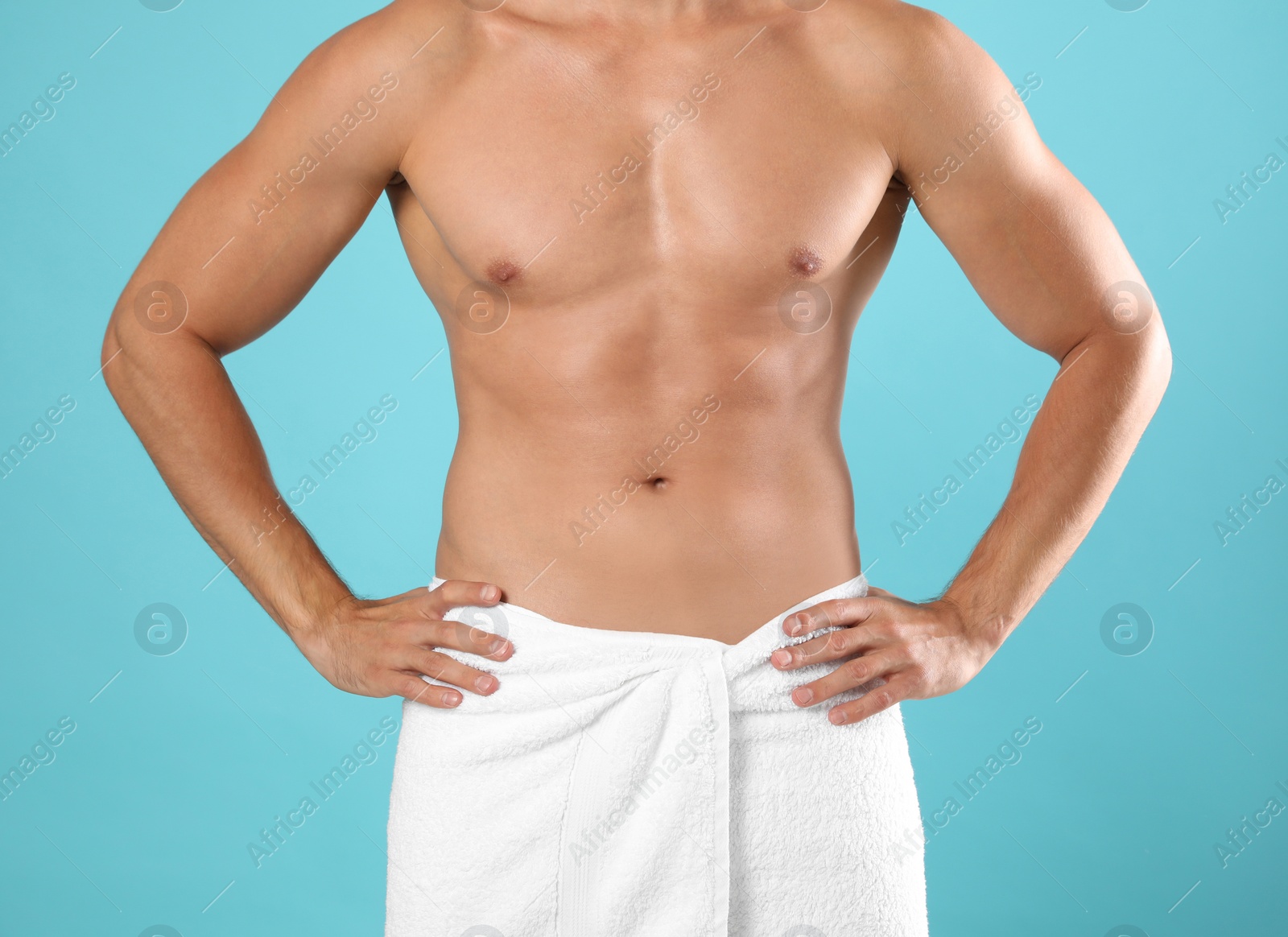 Photo of Young man with slim body on light blue background, closeup view