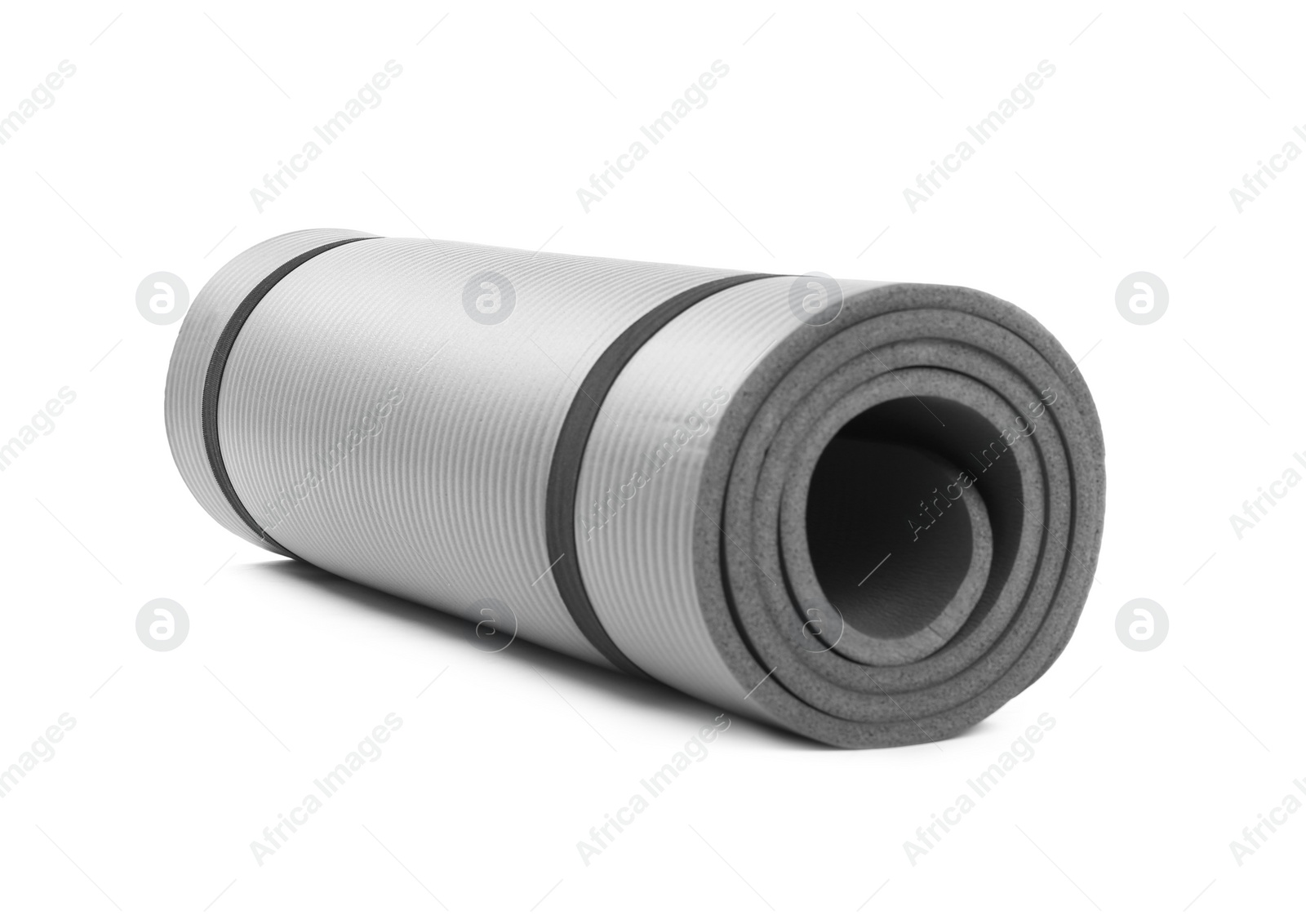 Photo of Rolled grey yoga mat on white background