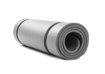 Rolled grey yoga mat on white background