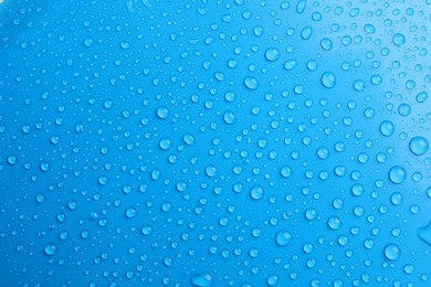 Photo of Water drops on light blue background, top view