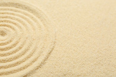 Photo of Zen rock garden. Circle pattern on beige sand