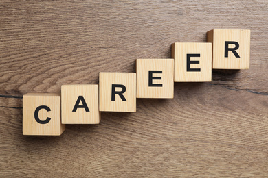 Cubes with word CAREER on wooden background, flat lay