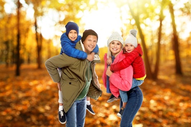 Image of Happy family spending time together at autumn park 