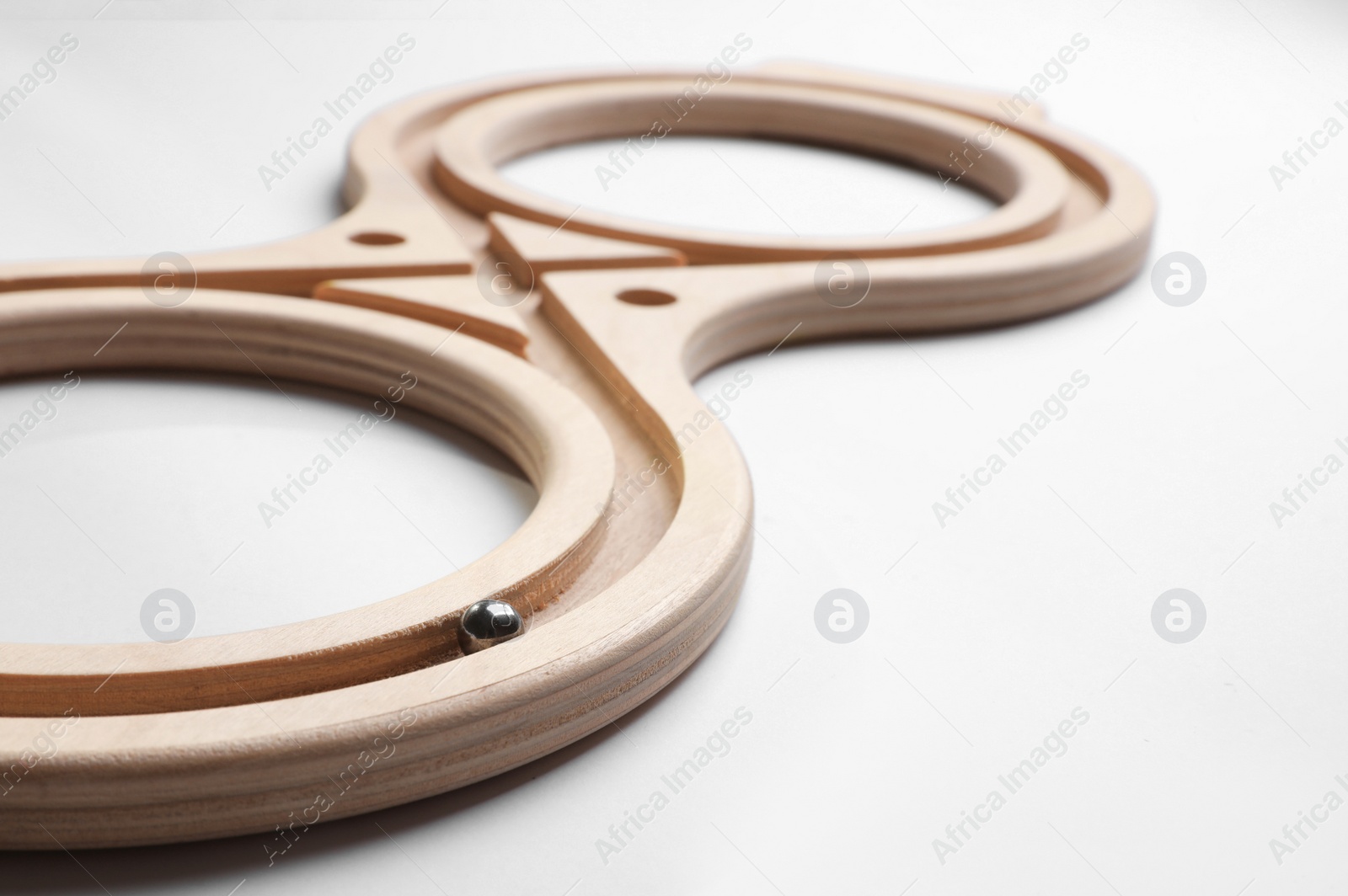 Photo of Labyrinth balance board on white background, closeup. Montessori toy