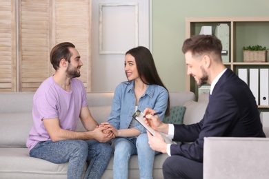 Photo of Family psychologist working with young couple in office
