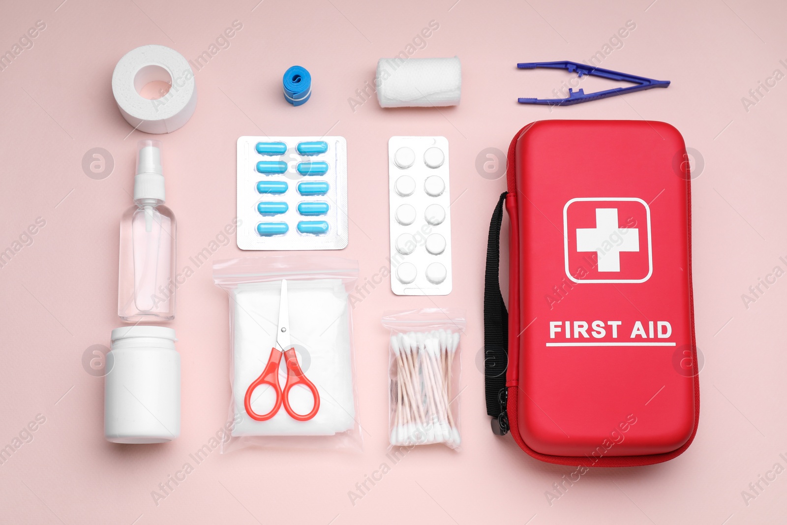 Photo of Flat lay composition with first aid kit on pink background