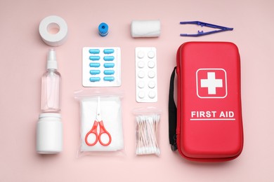 Photo of Flat lay composition with first aid kit on pink background