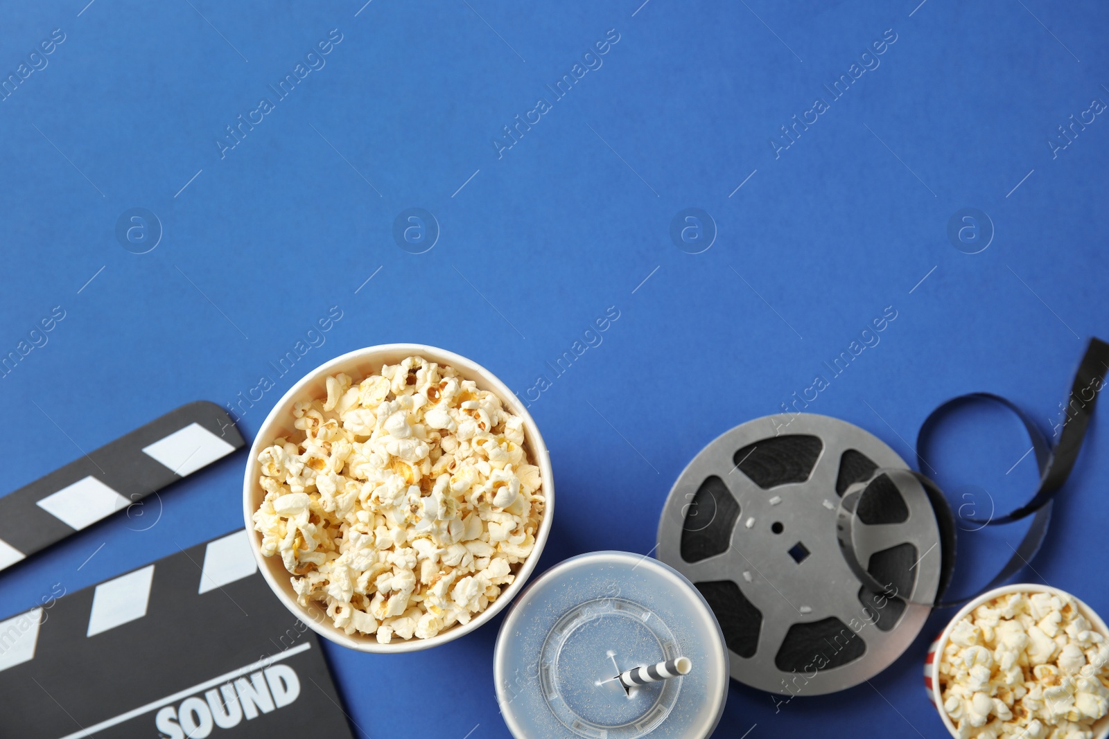 Photo of Flat lay composition with popcorn and space for text on color background. Cinema snack