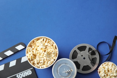 Photo of Flat lay composition with popcorn and space for text on color background. Cinema snack