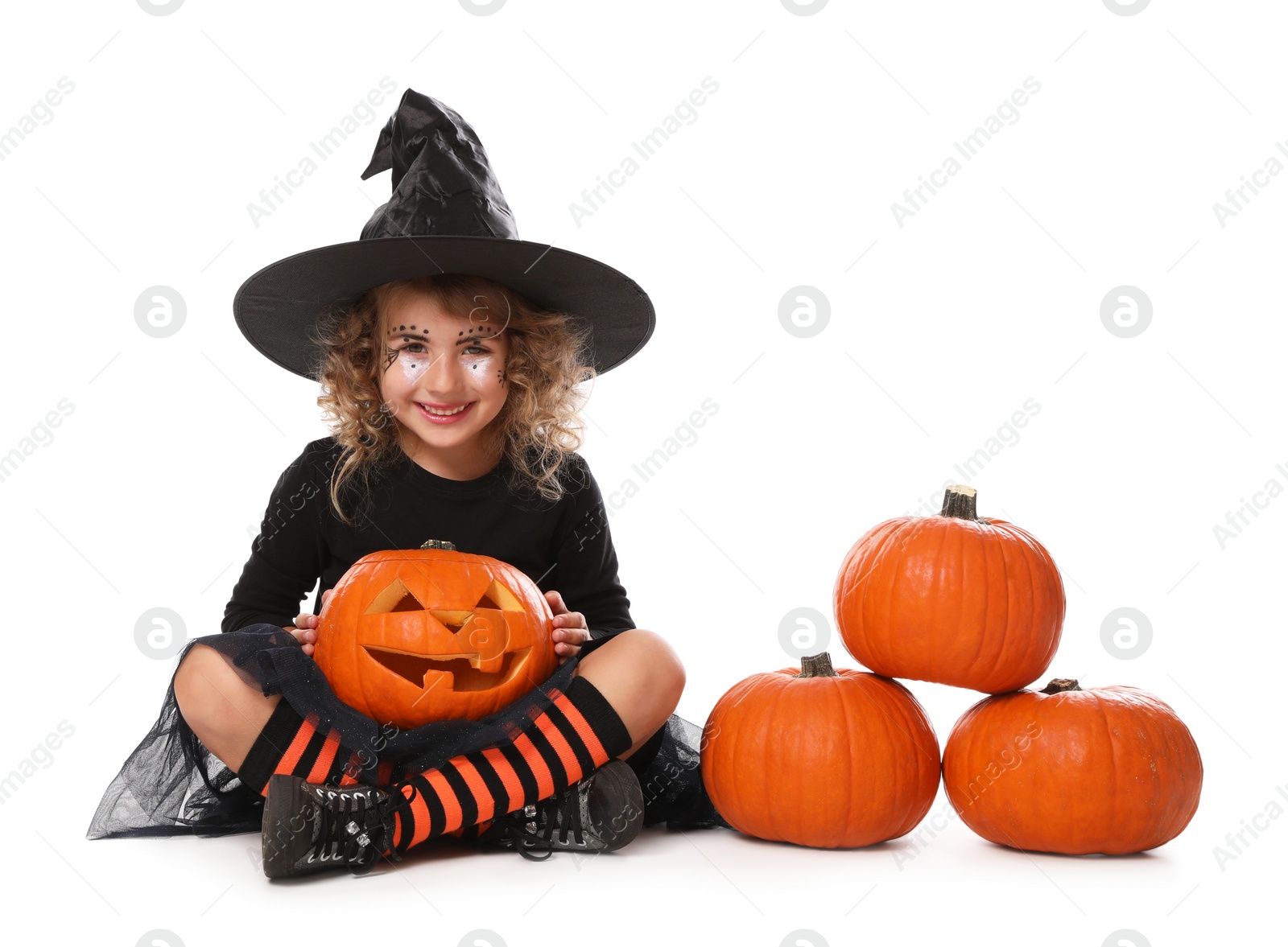 Photo of Cute little girl with pumpkin head jack lantern wearing Halloween costume on white background