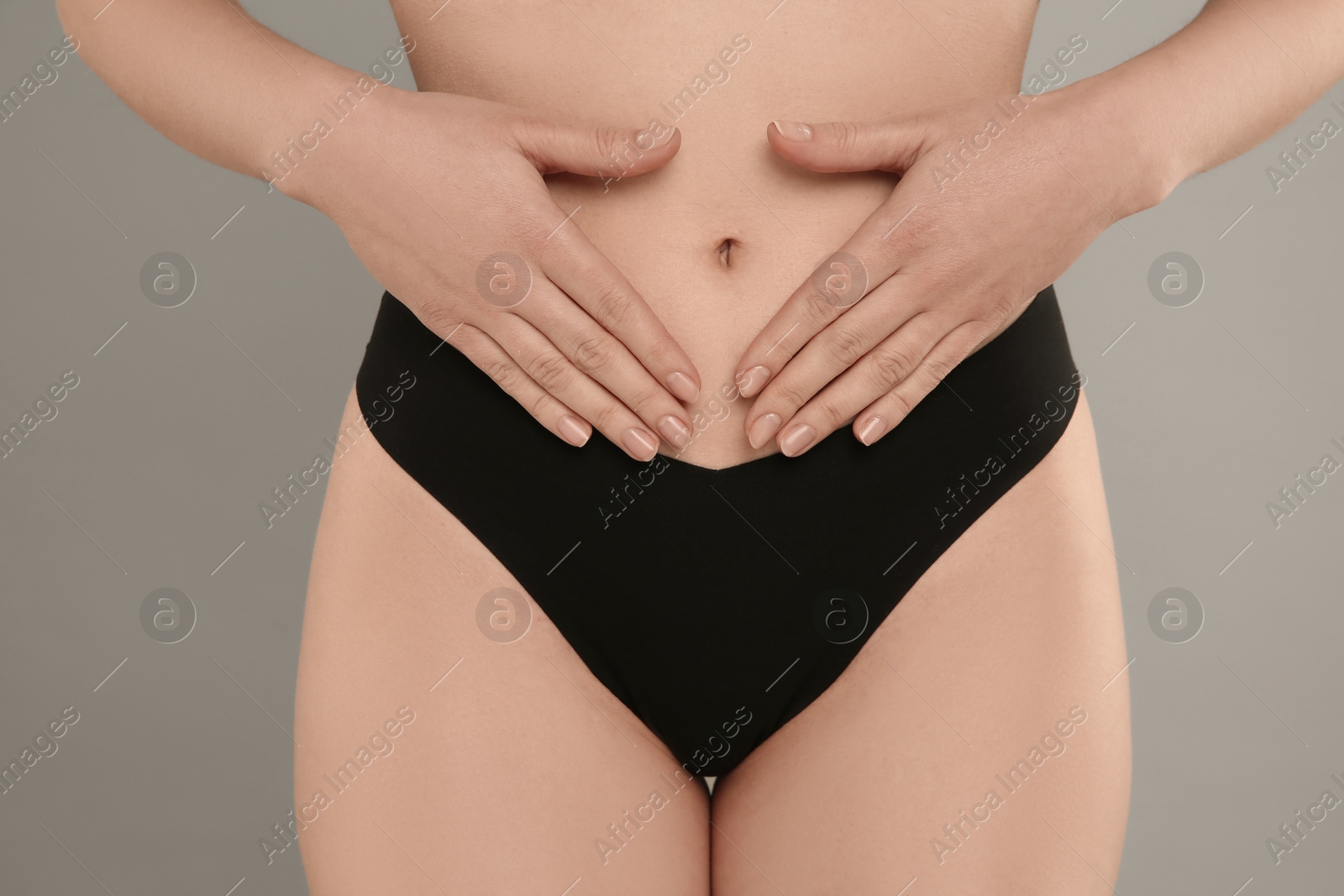 Photo of Gynecology. Woman in underwear on grey background, closeup