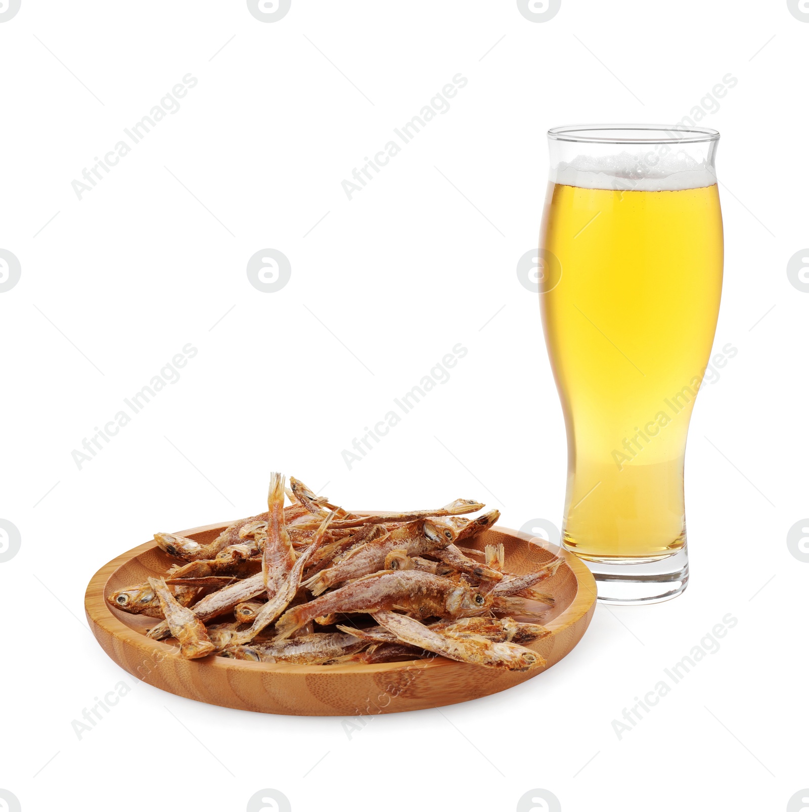 Photo of Tasty dried anchovies and glass of beer on white background