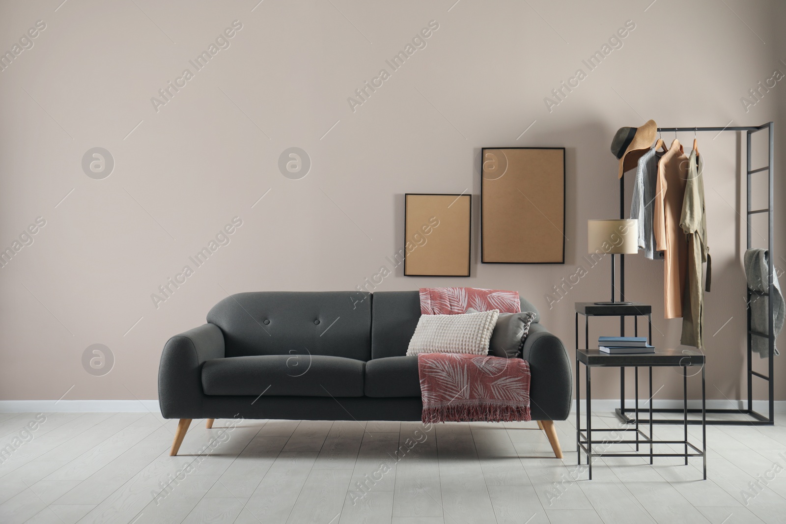 Photo of Living room interior with stylish comfortable sofa. Space for text