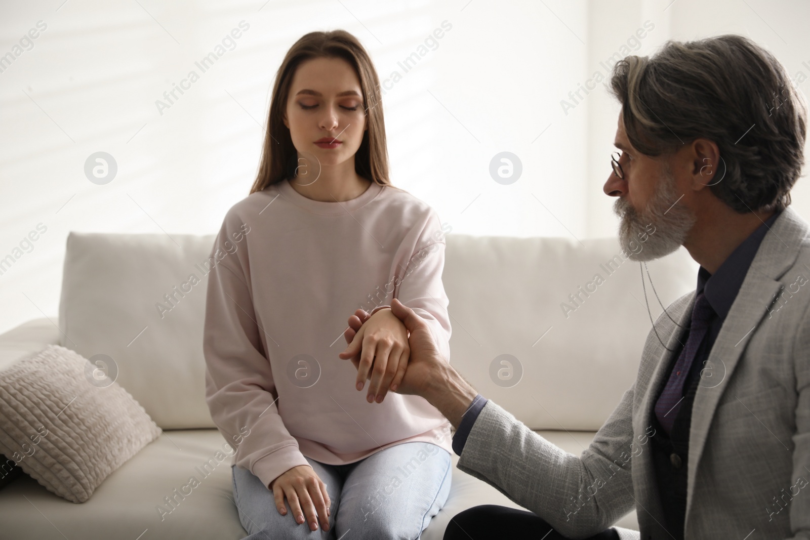 Photo of Psychotherapist and patient in office. Hypnotherapy session